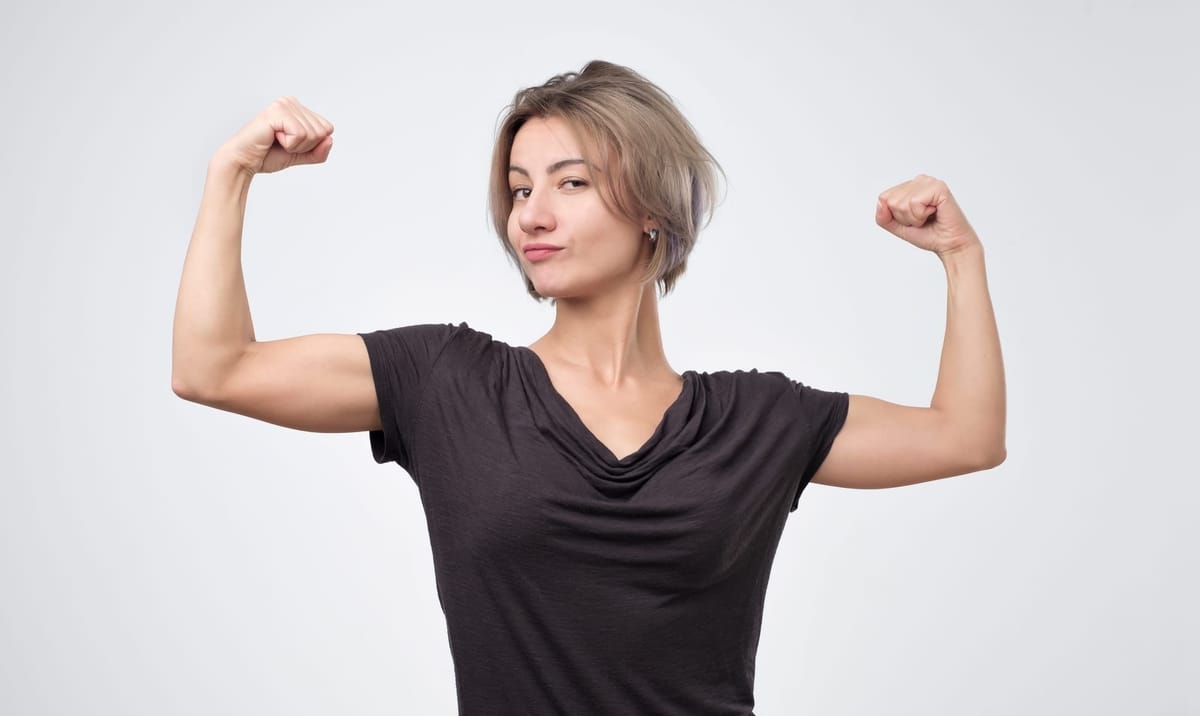 A woman with a strong and healthy immune system, flexing